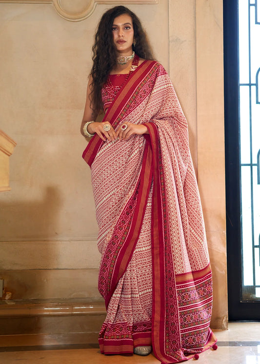 Detailed view of red patola motifs on a white silk base featuring traditional ethnic designs for 2026 weddings.