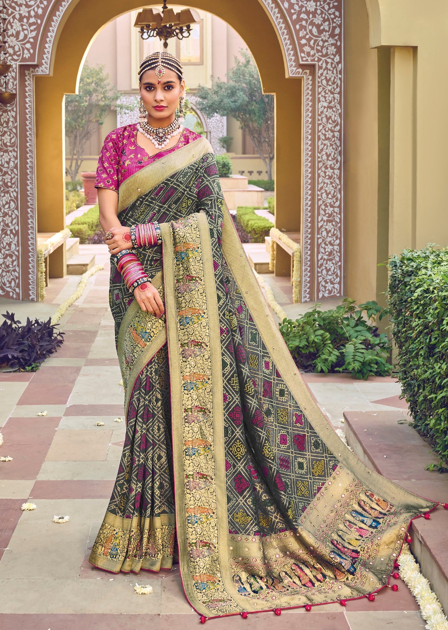 Woman standing in pink color blouse and black saree