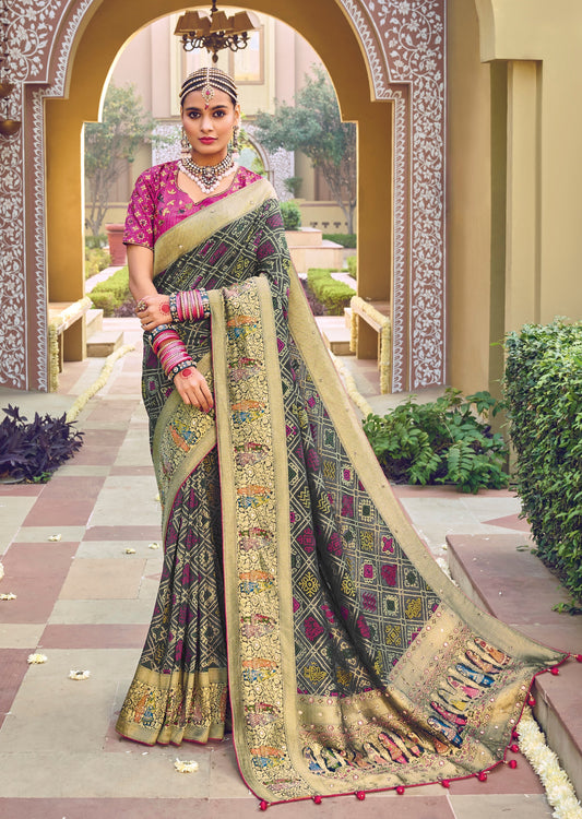 Woman standing in pink color blouse and black saree