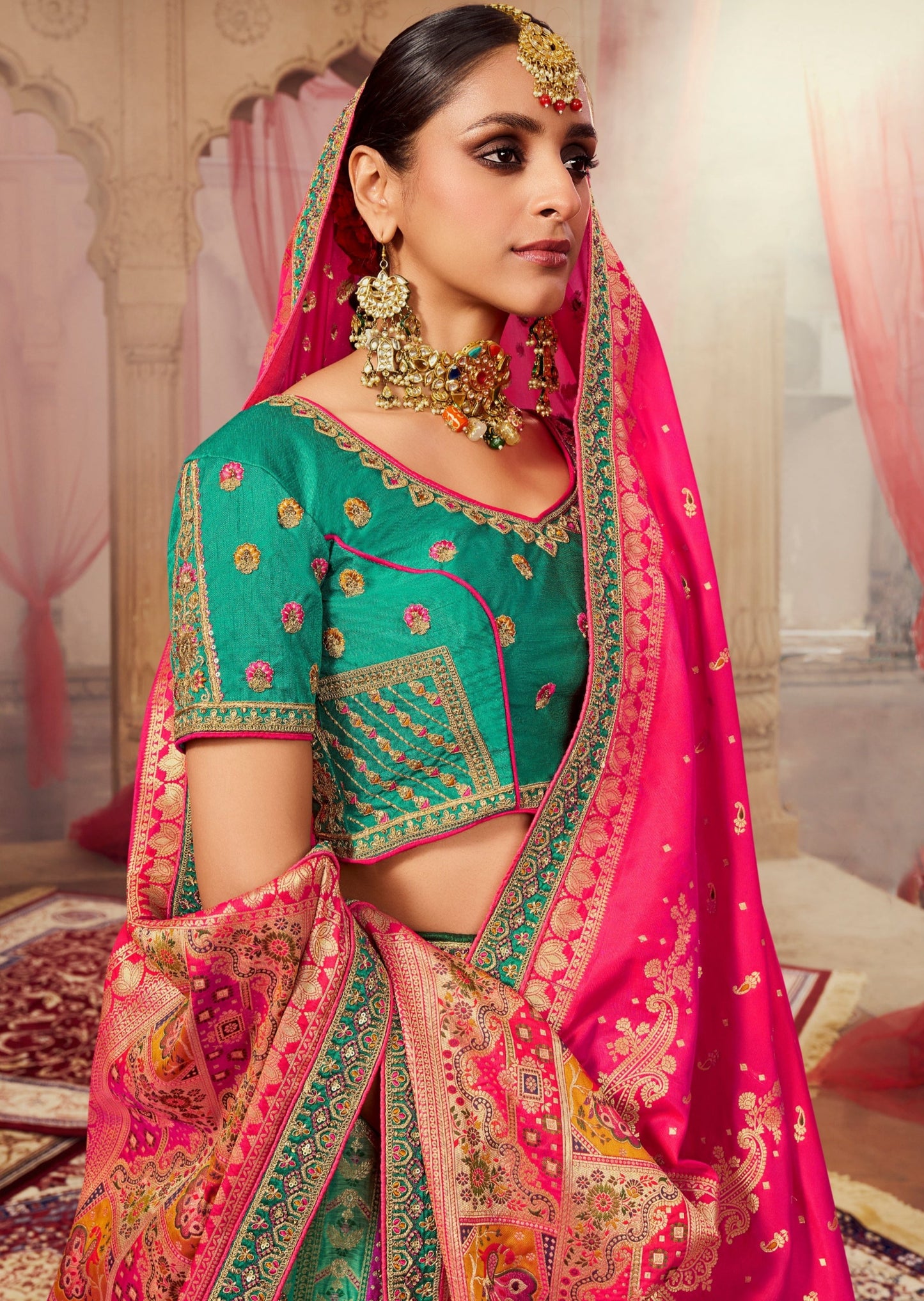 Woman in green banarasi silk lehenga choli.