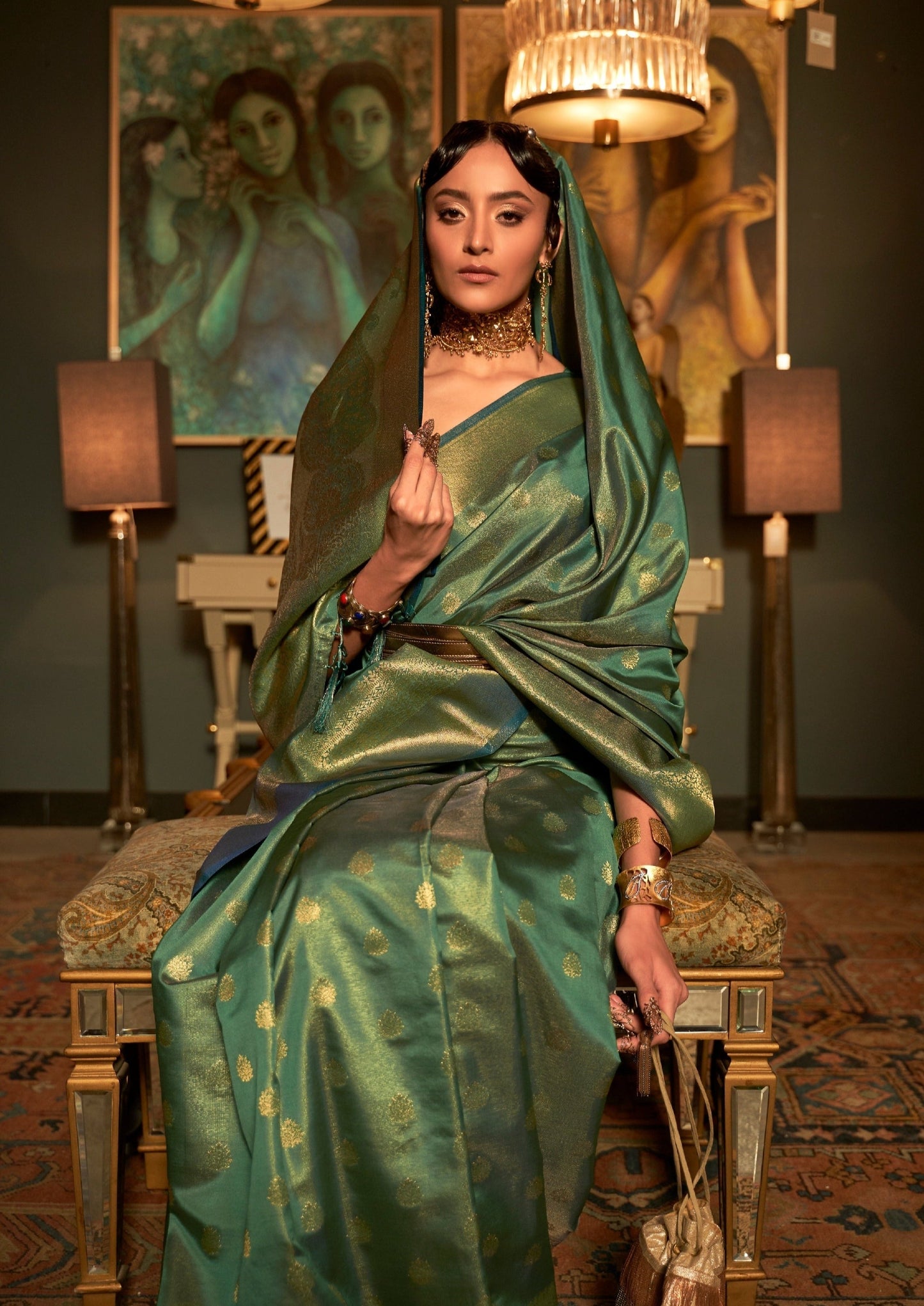 woman sitting in ghoonghat wearing green colour banarasi silk saree with golden border