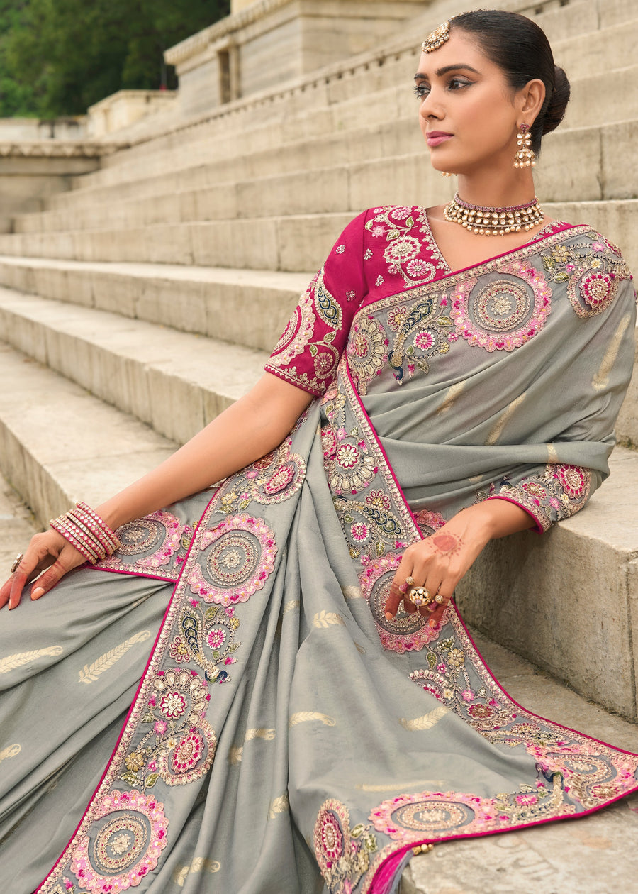 Designer grey banarasi tissue silk saree online with handloom weaving, cutwork border and contrasting pink blouse.