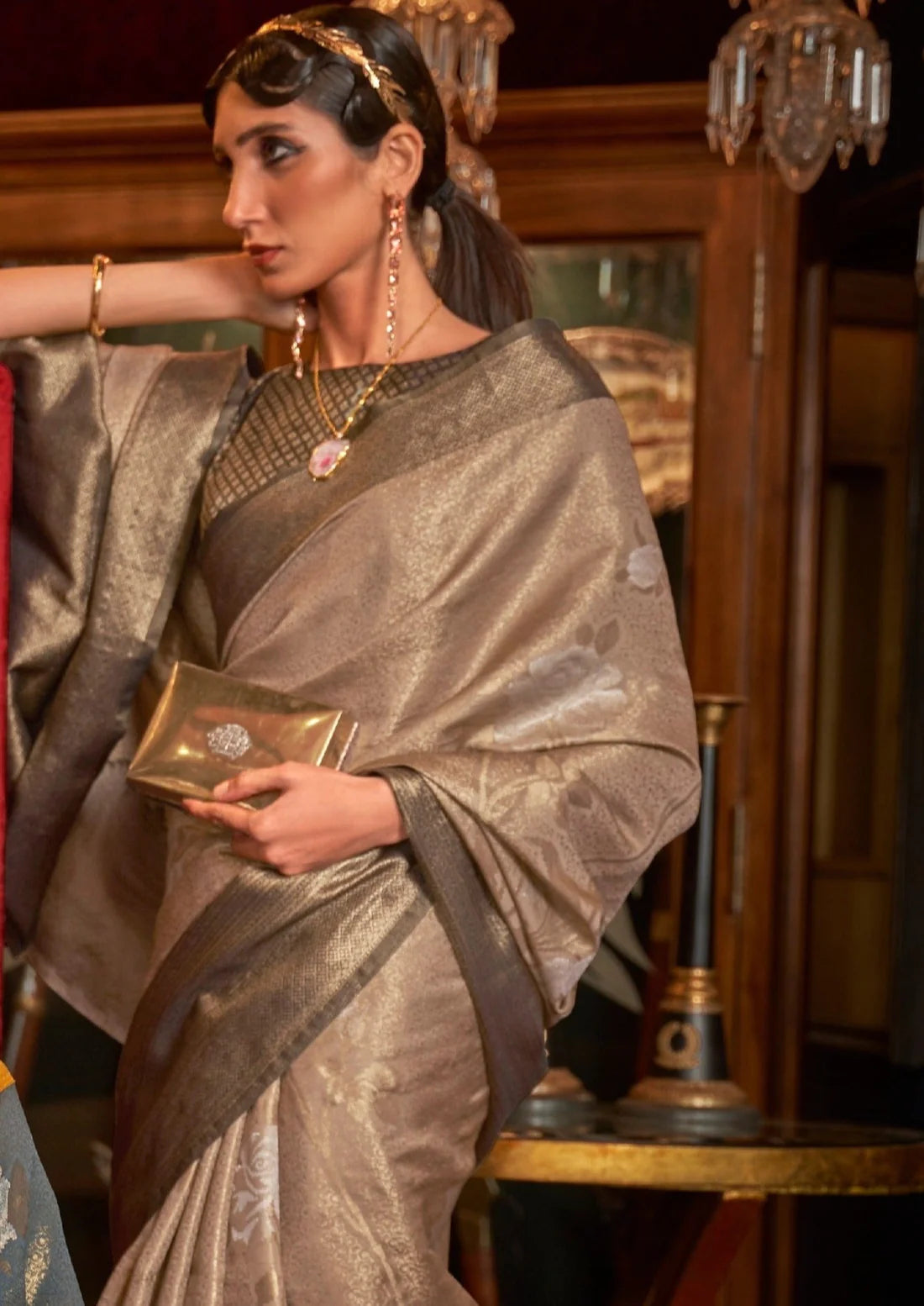 Woman in beige gold contrast kanjivaram silk saree in latest bridal designs.