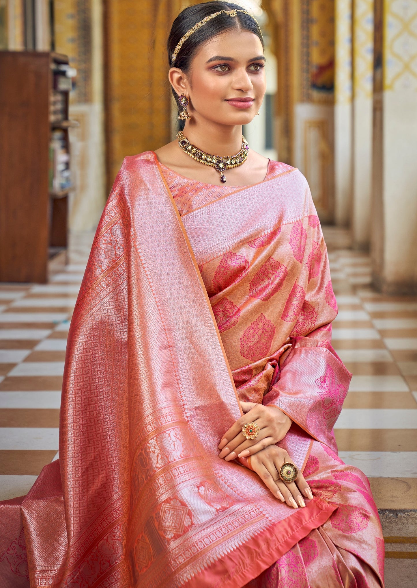 Woman smiling in blush pink pure kanchipuram silk saree online shopping with price.