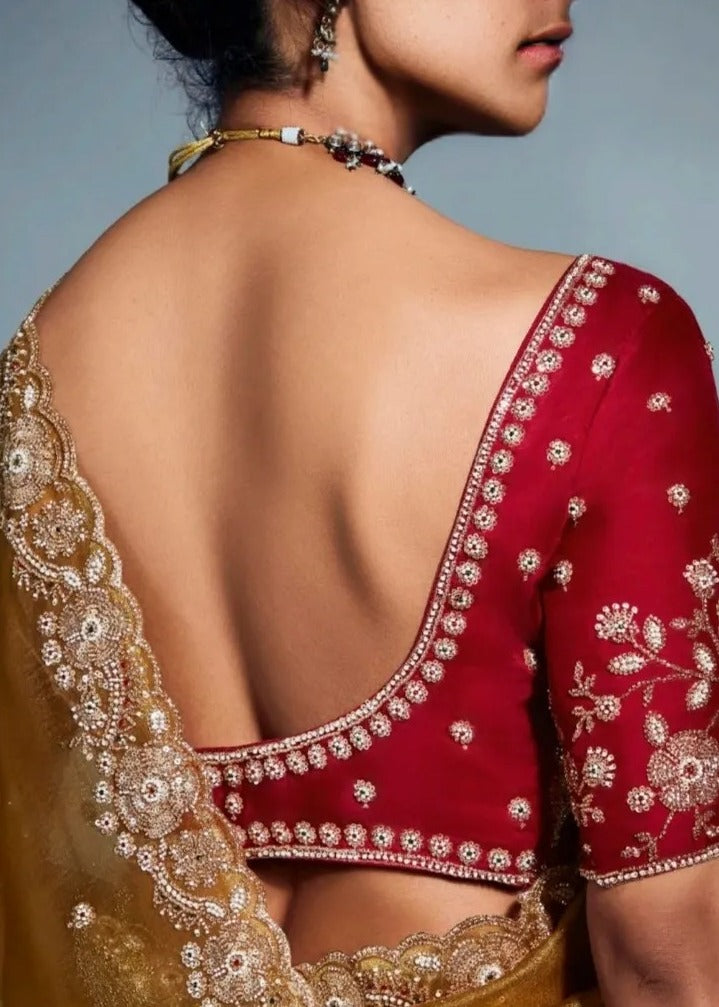 golden mustard yellow embroidered silk saree in usa for party wear made in pure tissue silk paired with red blouse.