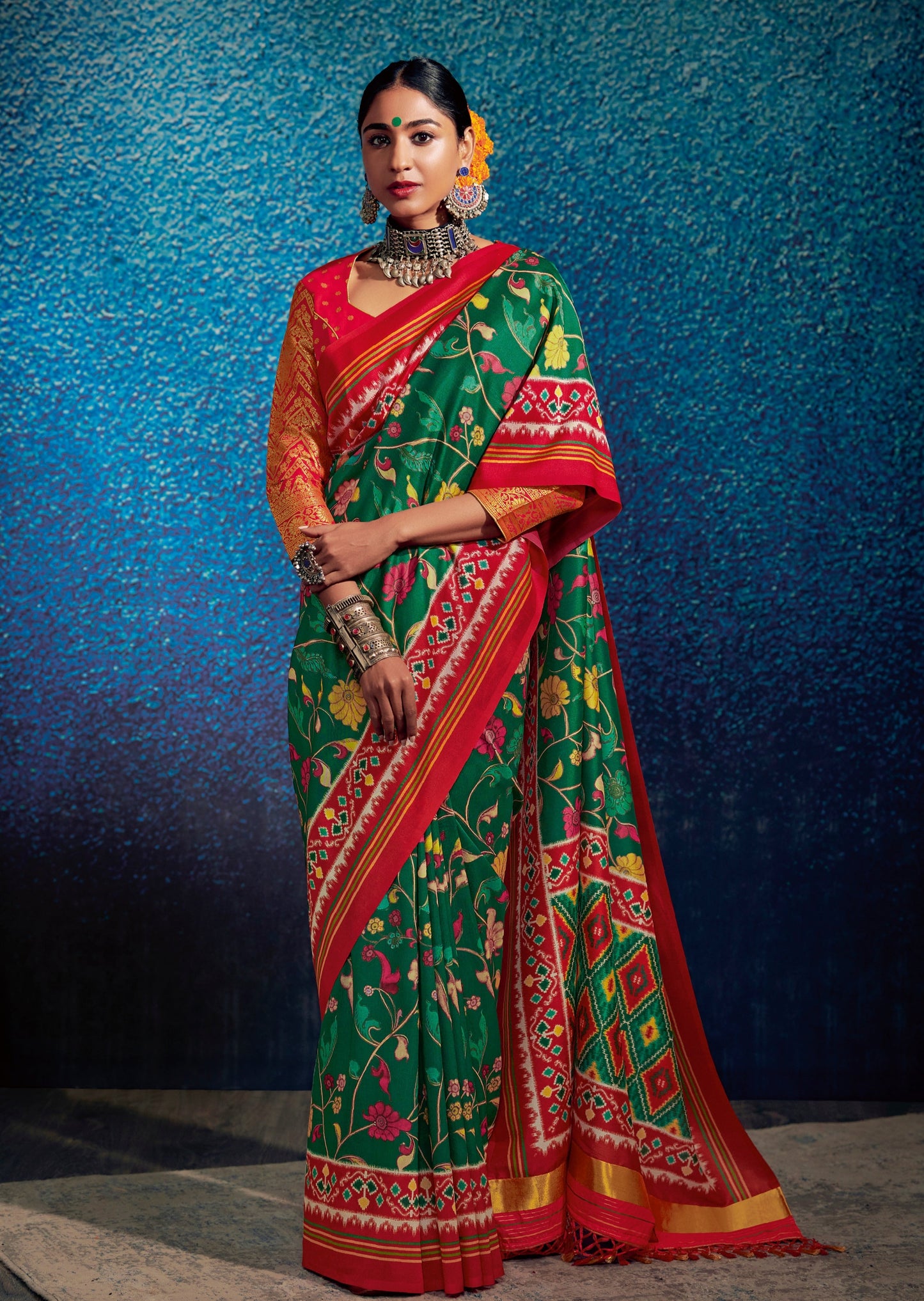 Woman standing in Green Kalamkari Patola Saree