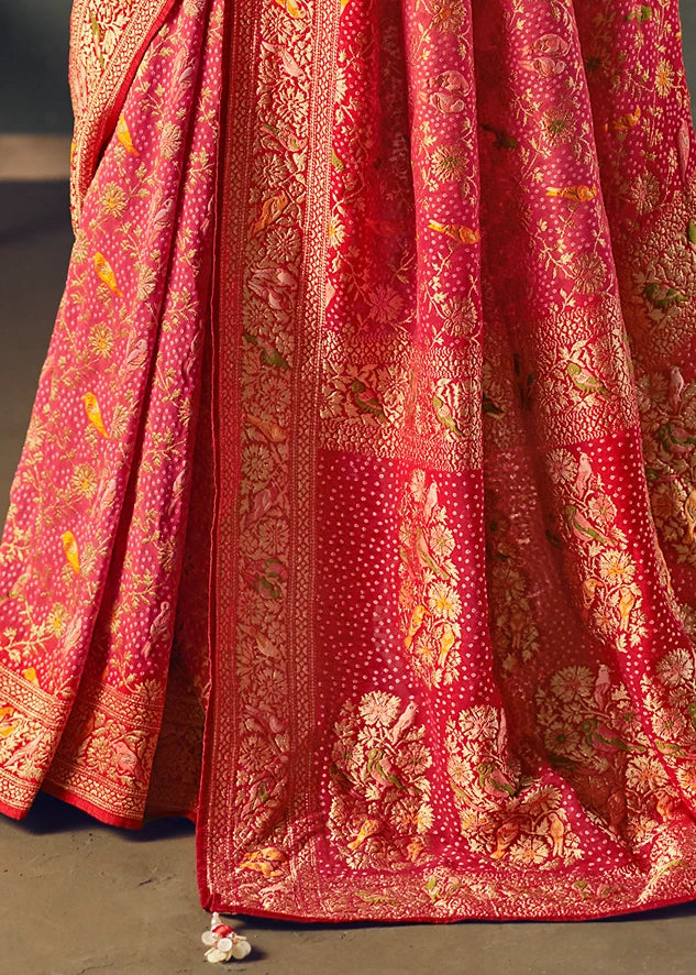 Pleats of a pastel pink bandhani saree made in pure khaddi banarasi georgette fabric, showcasing meenakari motifs and red border & pallu.