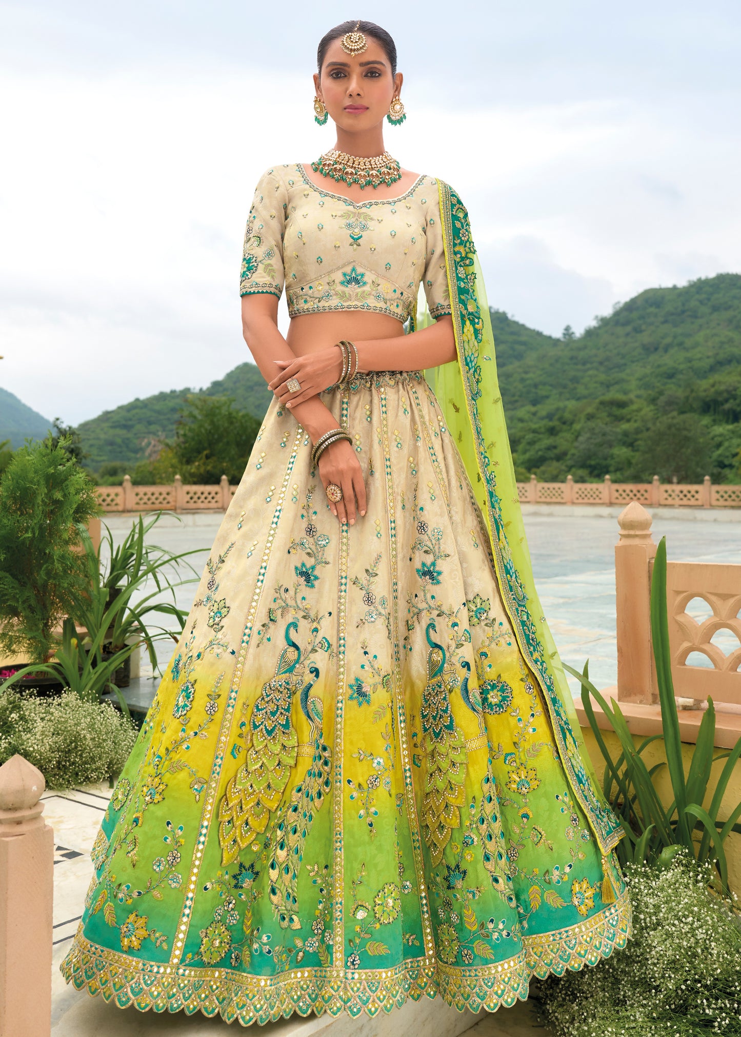 Cream and green designer silk lehenga choli with intricate embroidery, perfect for weddings and festivals in USA, UK and UAE.