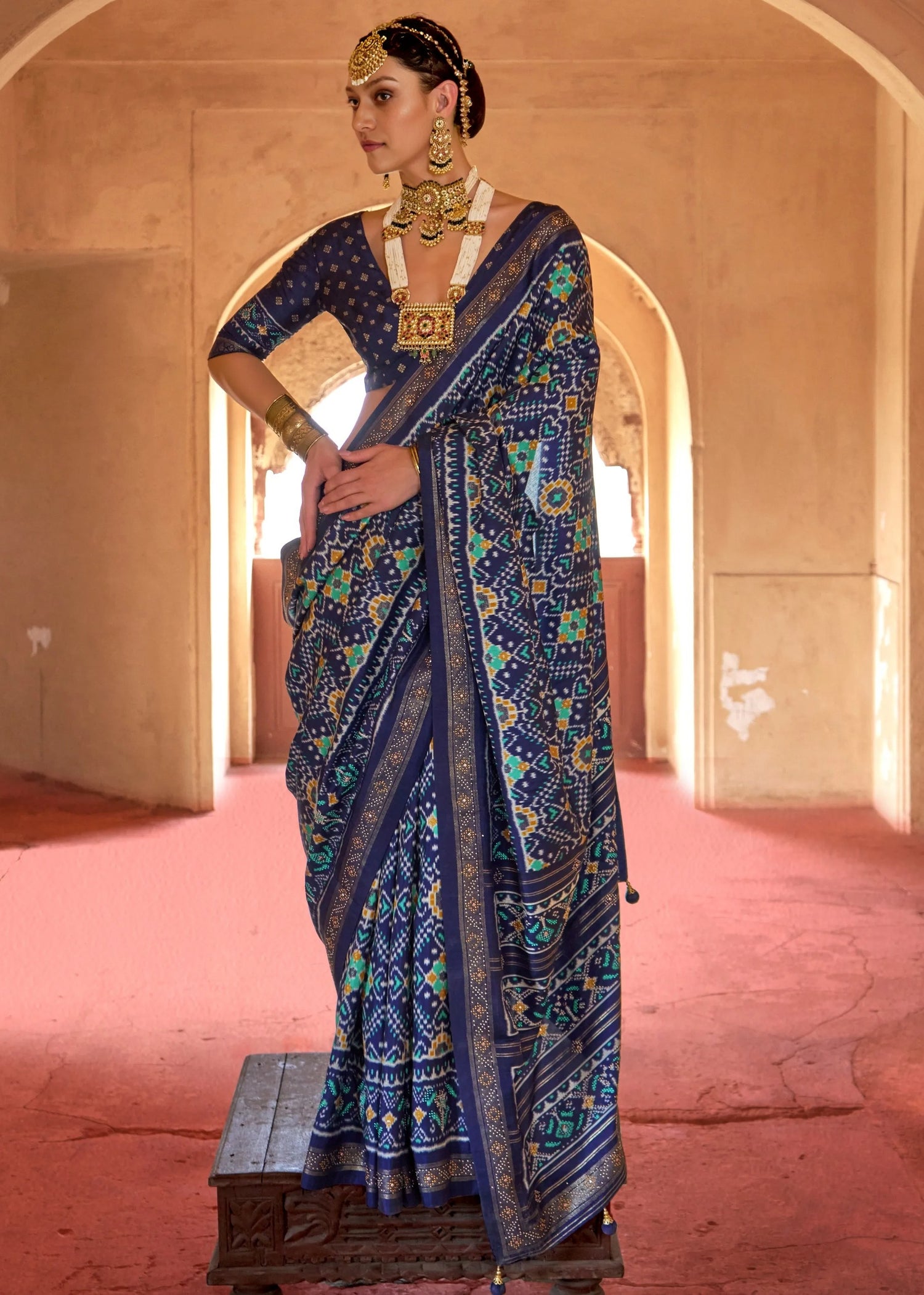 Traditional design navy blue patola silk saree with matching blouse for wedding function featuring classic patola design patterns and lustrous finish.