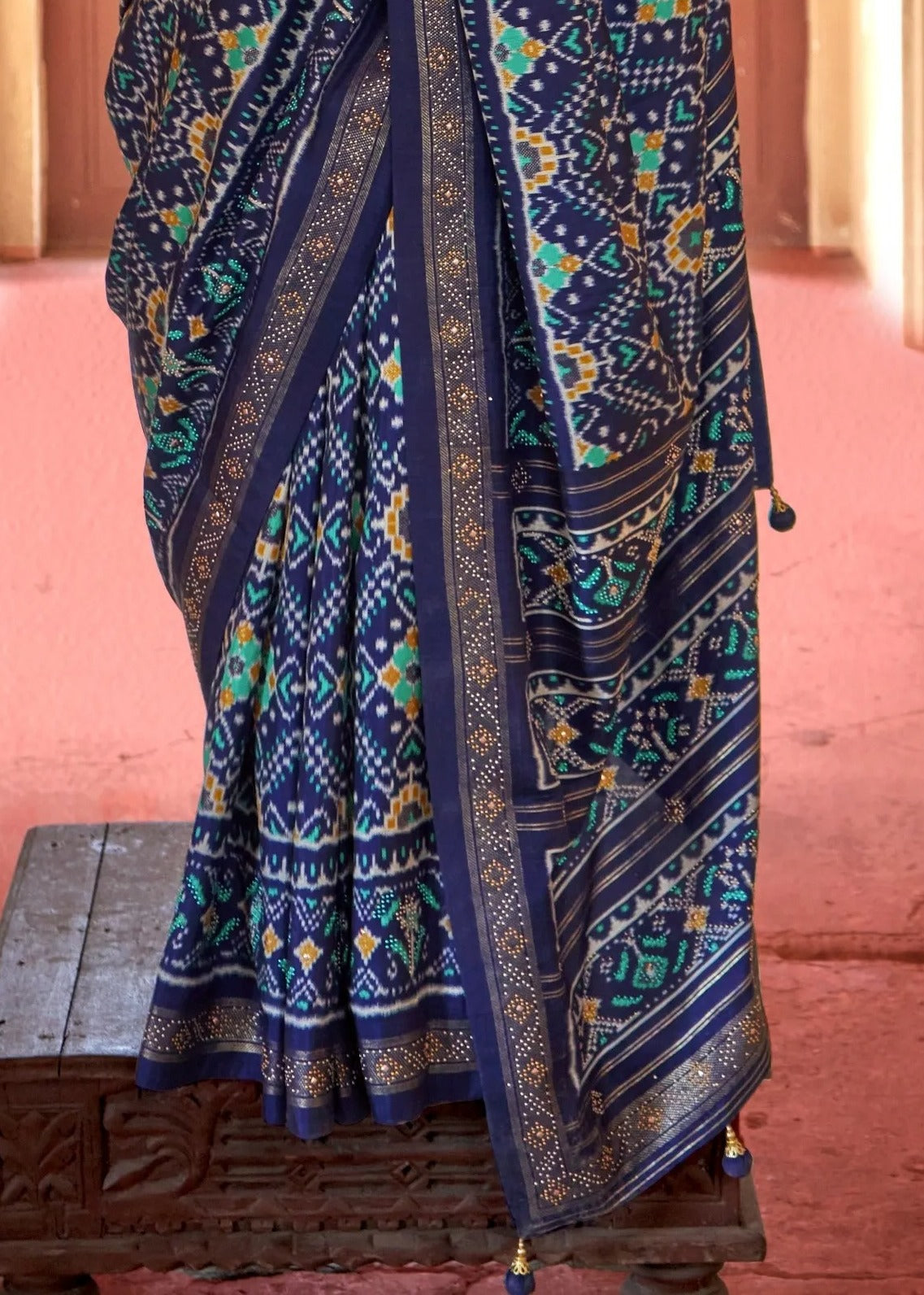 Traditional navy blue patola saree drape pallu design showing geometric and floral patola patterns on pure silk.