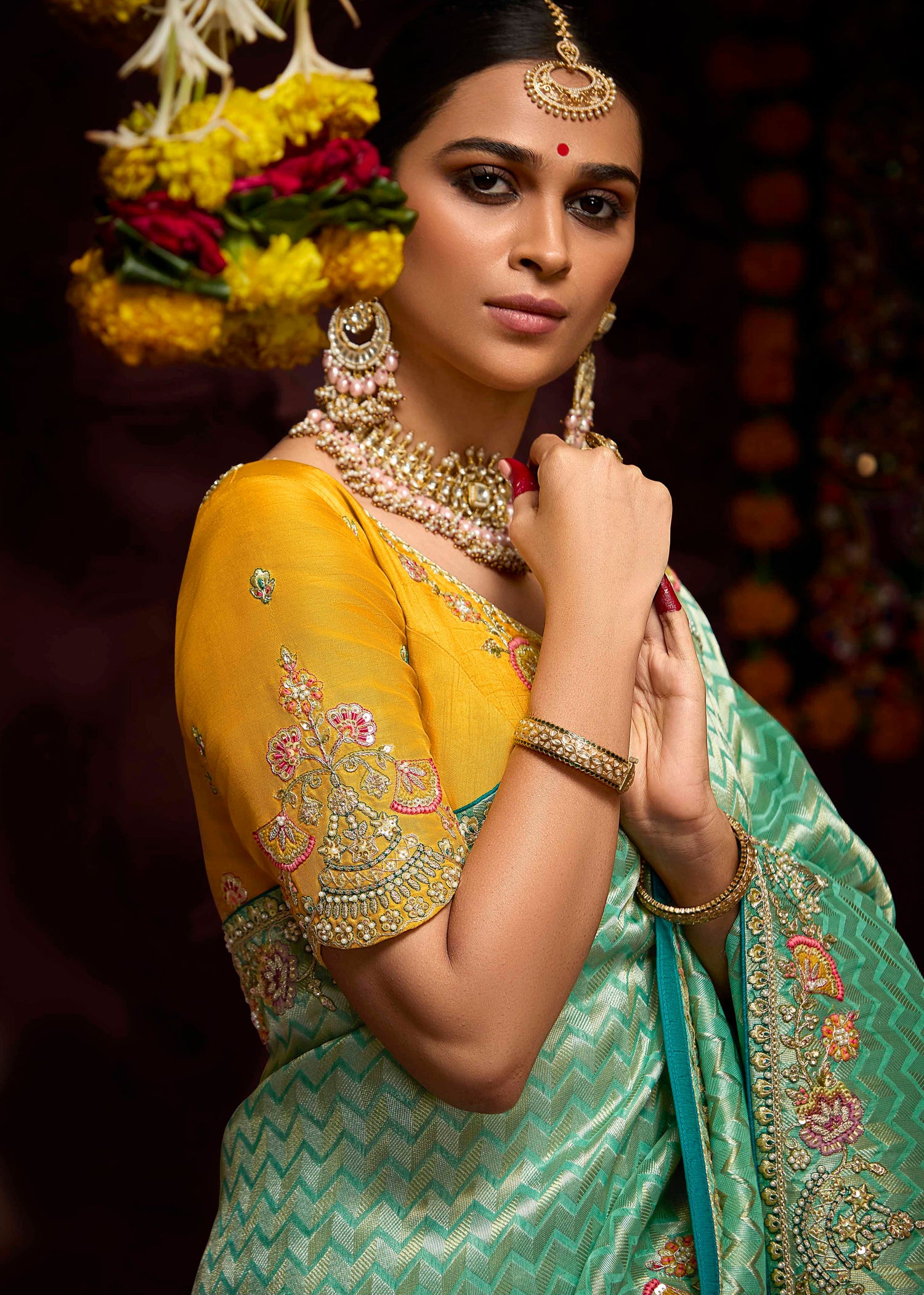Exquisite ocean green and yellow banarasi silk bridal saree with traditional handcrafted embroidery.