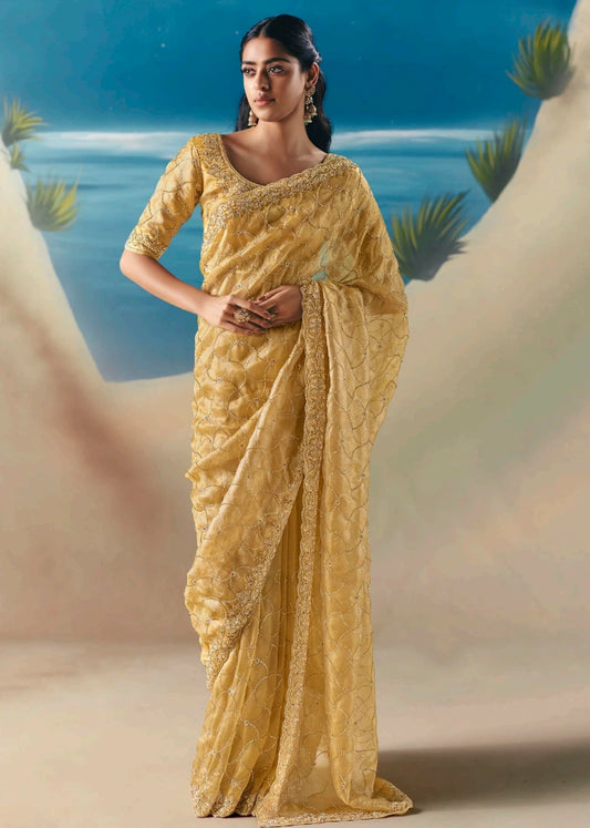 Pastel yellow organza tissue silk hand embroidered bridal saree with beadwork and sequins embroidery for wedding, engagement and haldi.