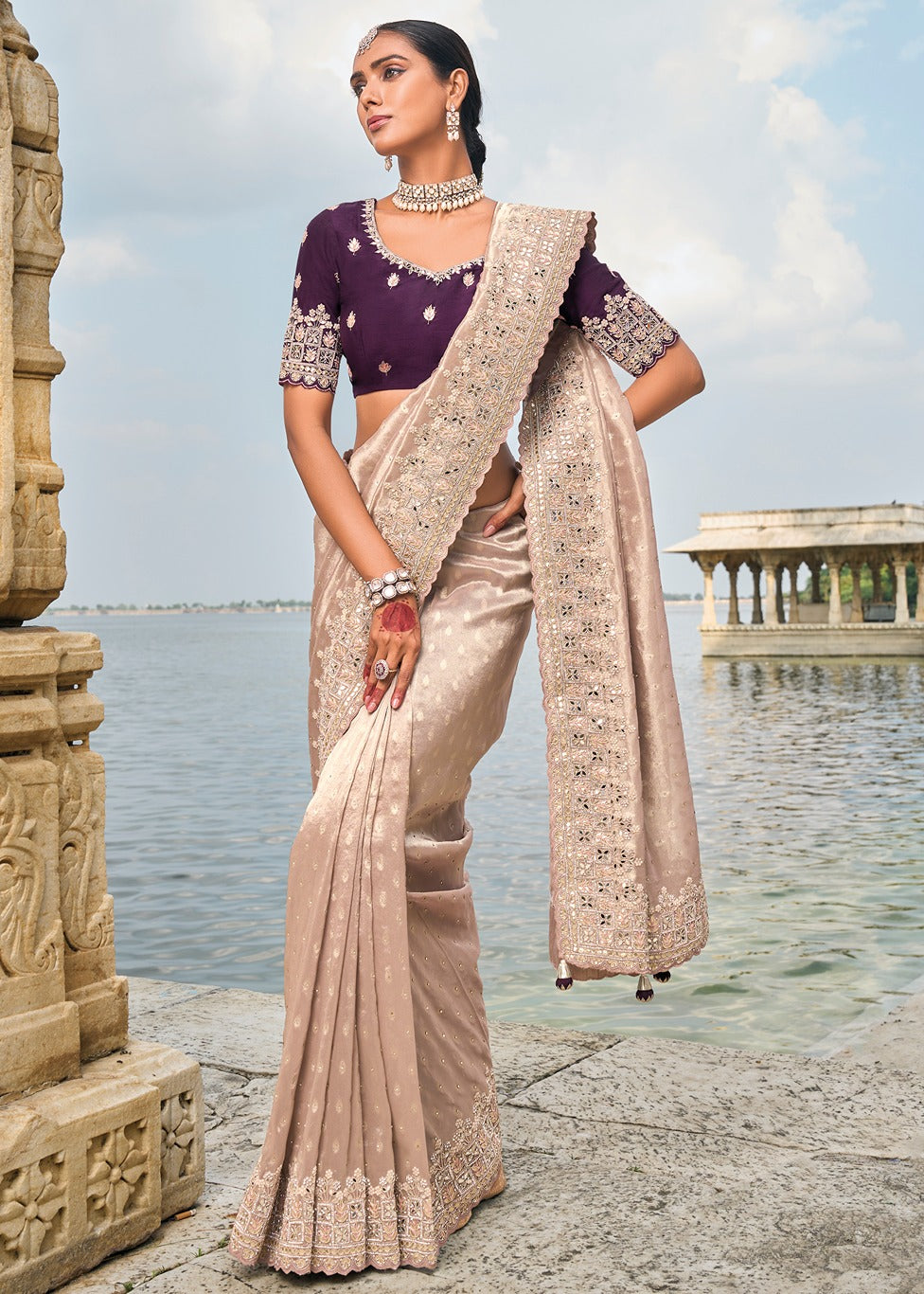 Peach banarasi silk saree with hand embroidery and violet purple blouse for wedding, festive or engagement wear.