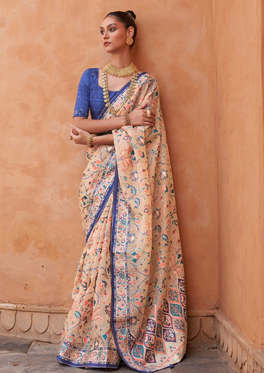 Bride in peach tissue saree with blue blouse.