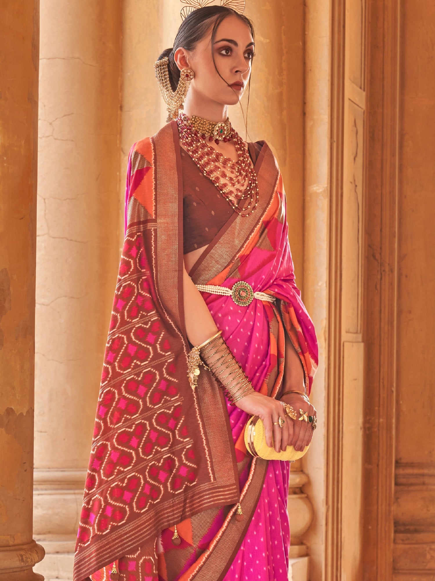 Bride in pink patola silk double ikkat saree blouse.