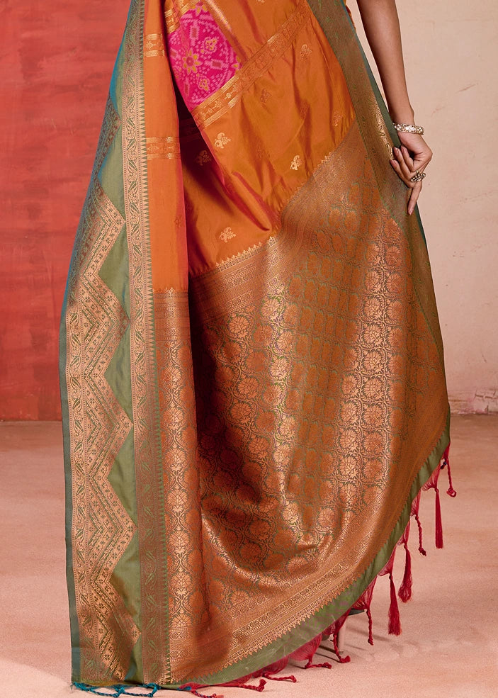 Vibrant orange Pochampally Patola Silk Saree with intricate Mehendi Green Ikkat border and blouse, a stunning example of traditional Indian handloom craftsmanship, ideal for weddings, festivals, and special occasions.