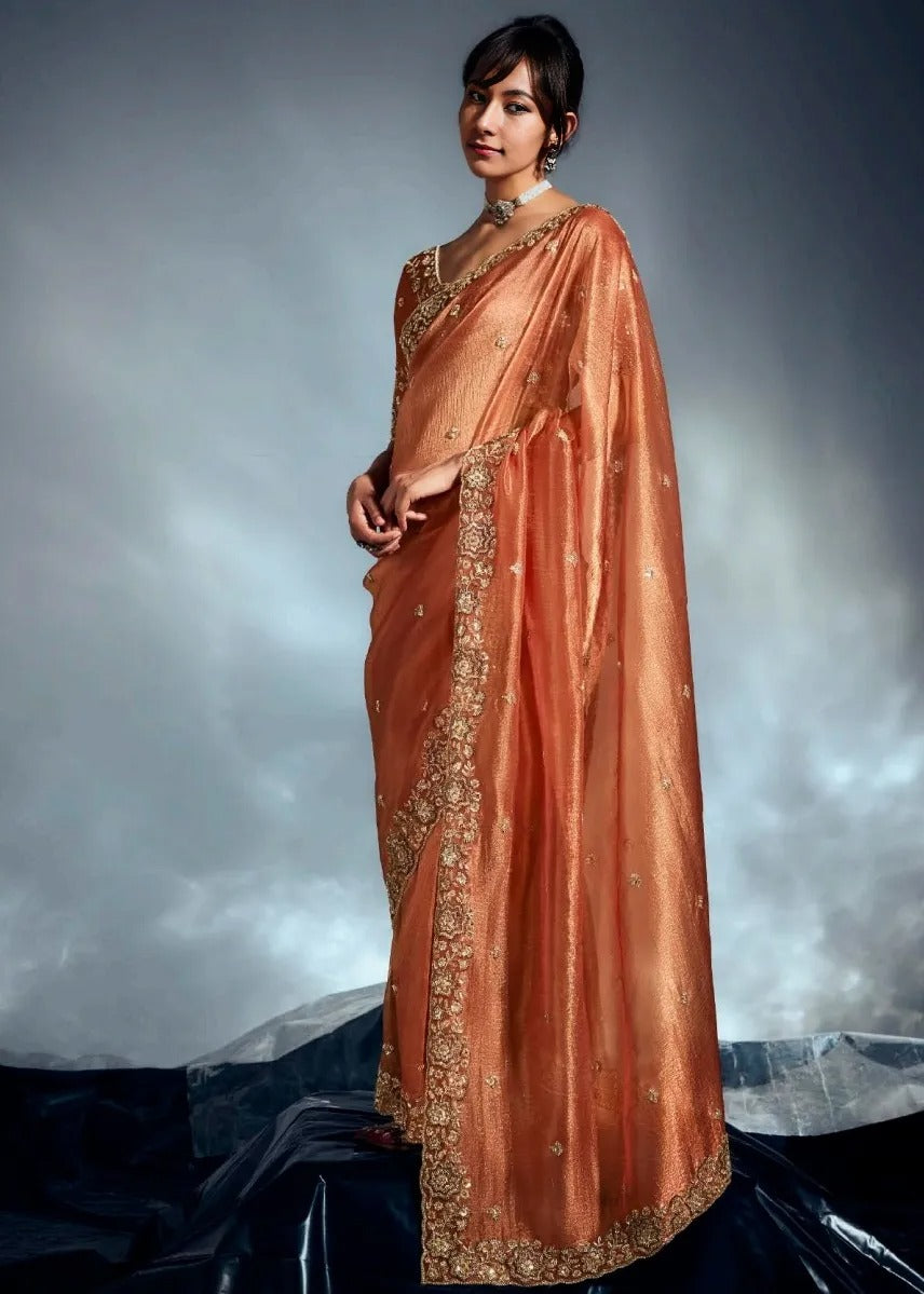 Premium bridal rust orange embroidered tissue silk saree with rich detailing for women featuring delicate hand embroidery work.