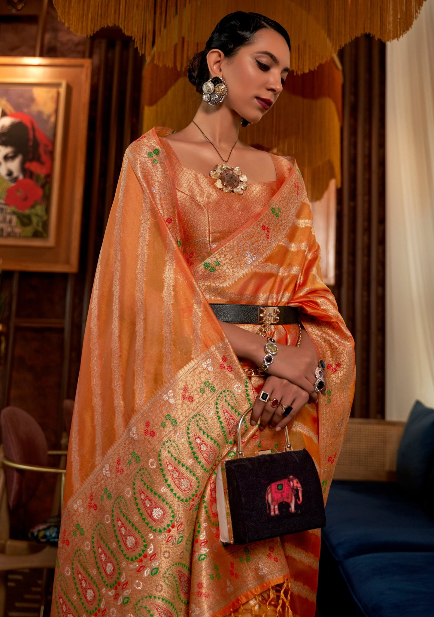 woman in Pure Handloom Banarasi Organza Saffron Orange Saree shows meenakari designs on pallu
