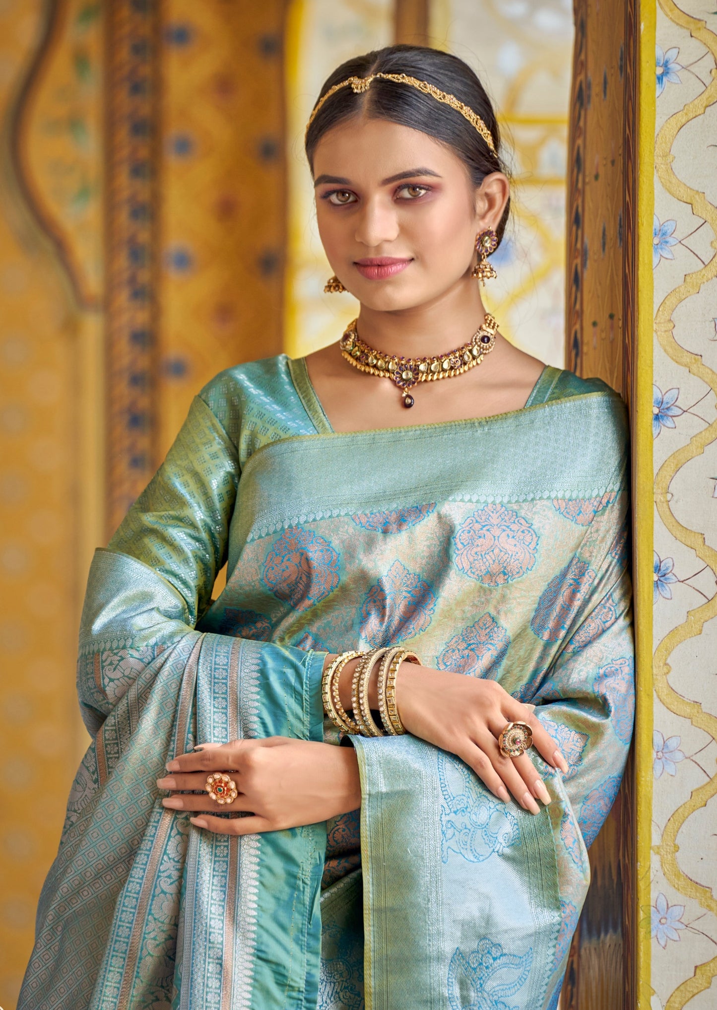 Portrait image of Woman standing in blue color silk saree