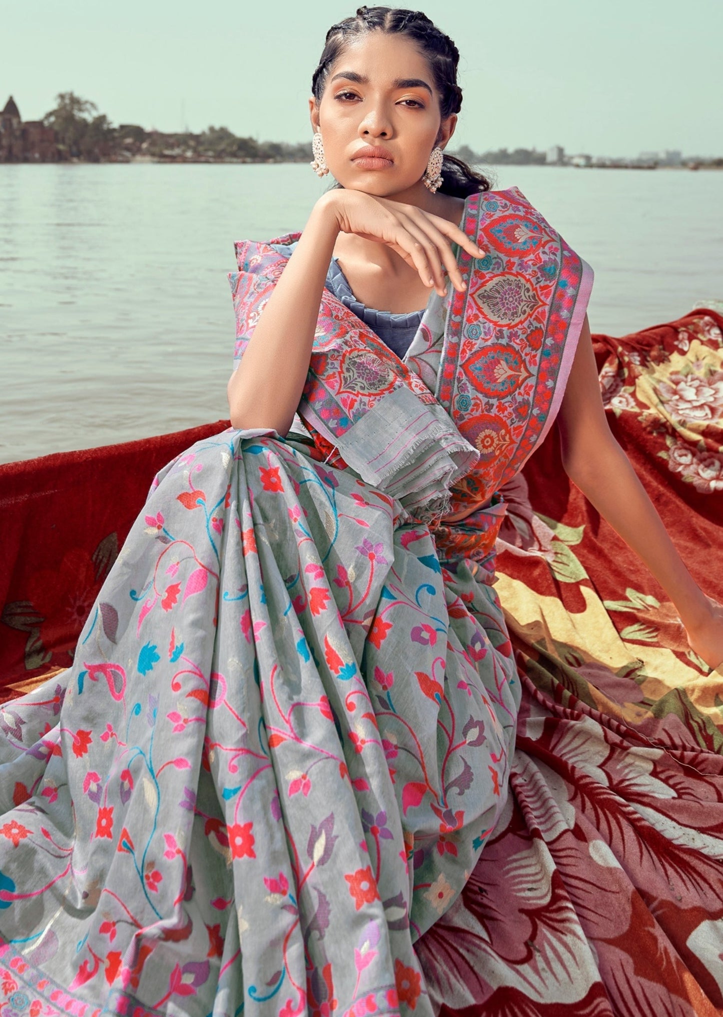 woman wearing Pure Kashmiri Pashmina Silk Embroidered Grey Handloom Saree sitting on woolen blanket holding her chin on right hand