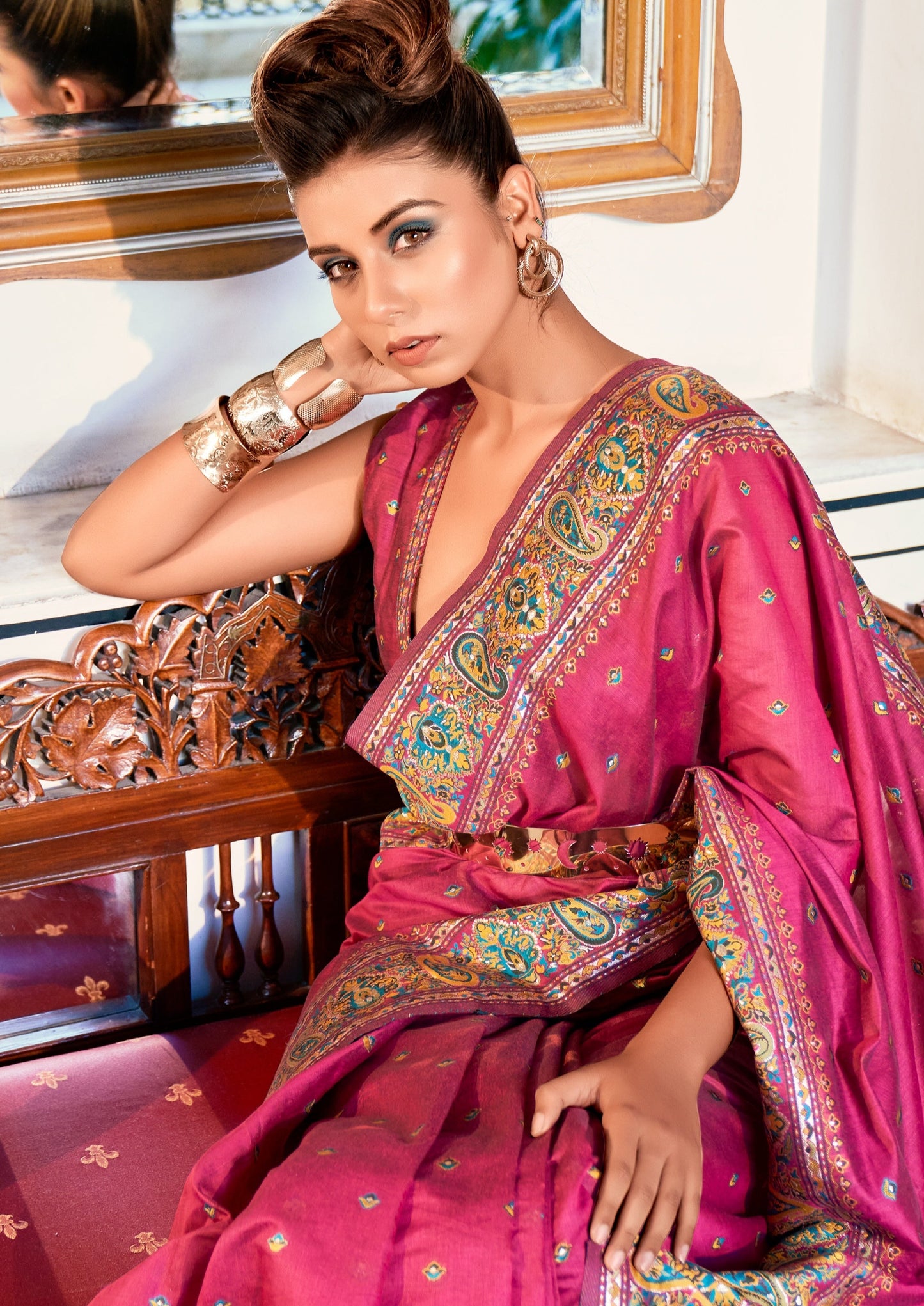 woman close up photo where she is sitting on wooden bending Pure Kashmiri Pashmina Silk Embroidered Red Handloom Saree