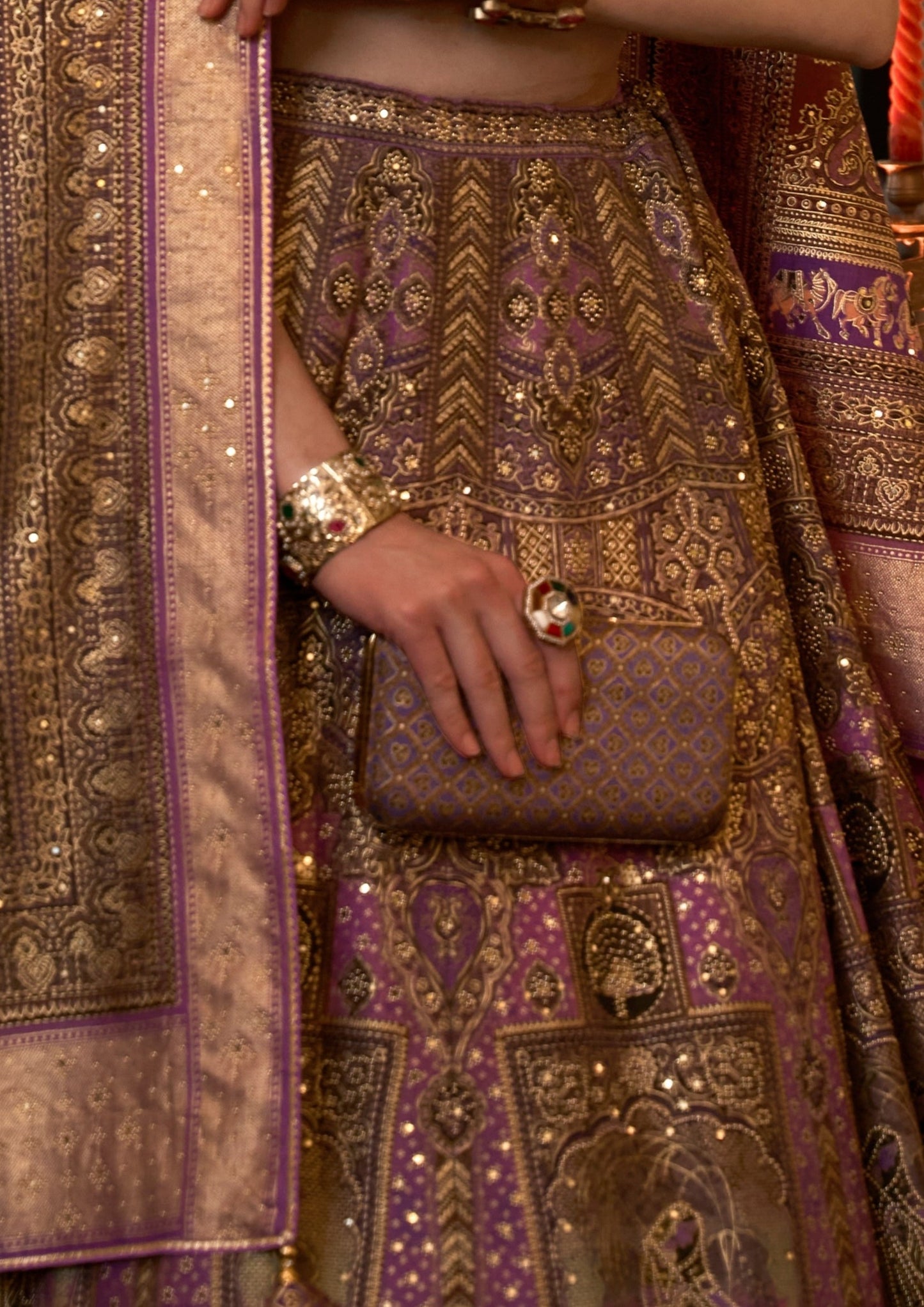 golden hand work on purple lehenga