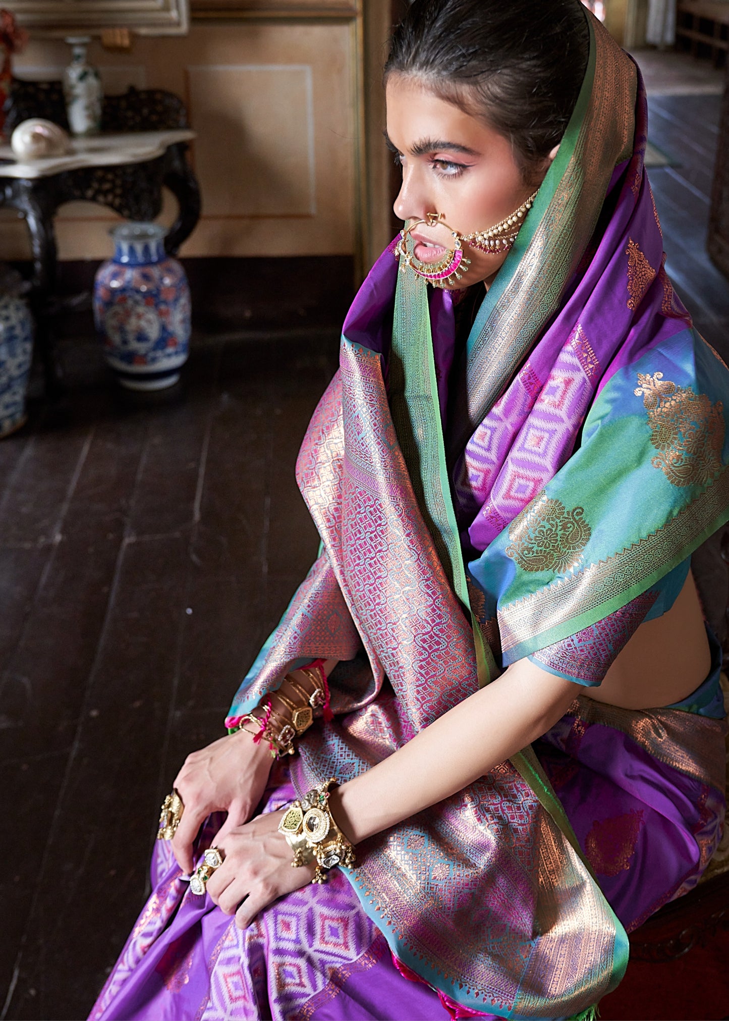 Close-up of zari work on purple green kanjivaram silk saree – online india store.
