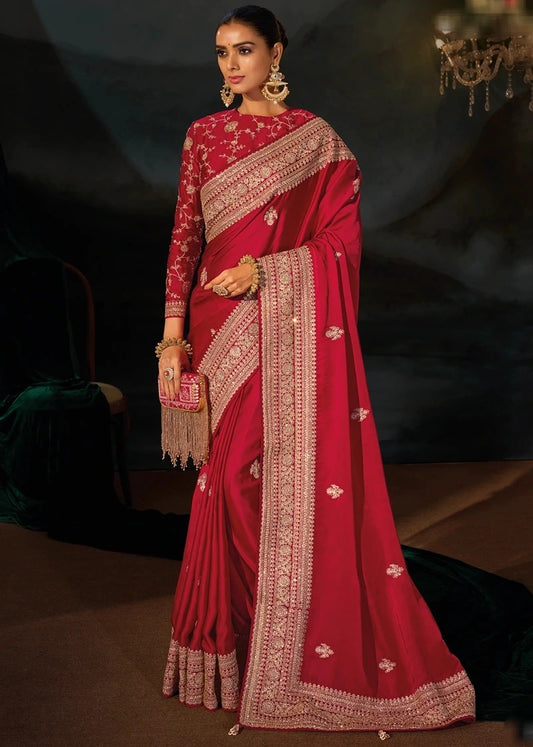 Front view of a royal red silk saree draped elegantly, displaying intricate golden embroidery.