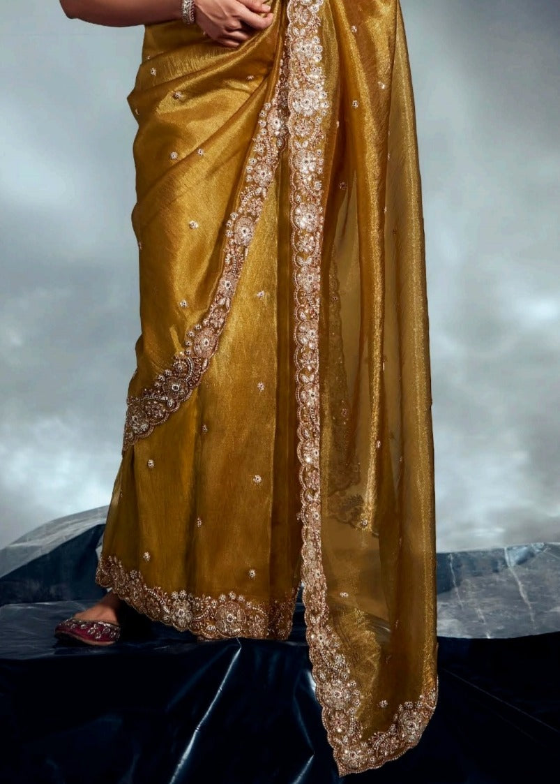 Premium festive traditional tissue silk mustard yellow saree in usa for haldi ceremony and wedding function featuring golden zari designer embroidery work.