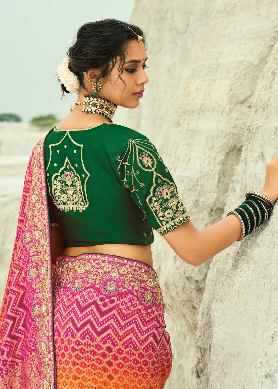 Traditional bandhani saree with orange pink gradient, handmade tie-dye dots and festive embroidery highlights.