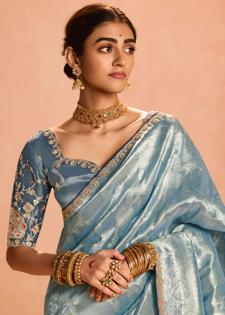 Traditional pure banarasi tissue silk saree in pastel blue with fine embroidery and contrast grey blouse for bridal wear.
