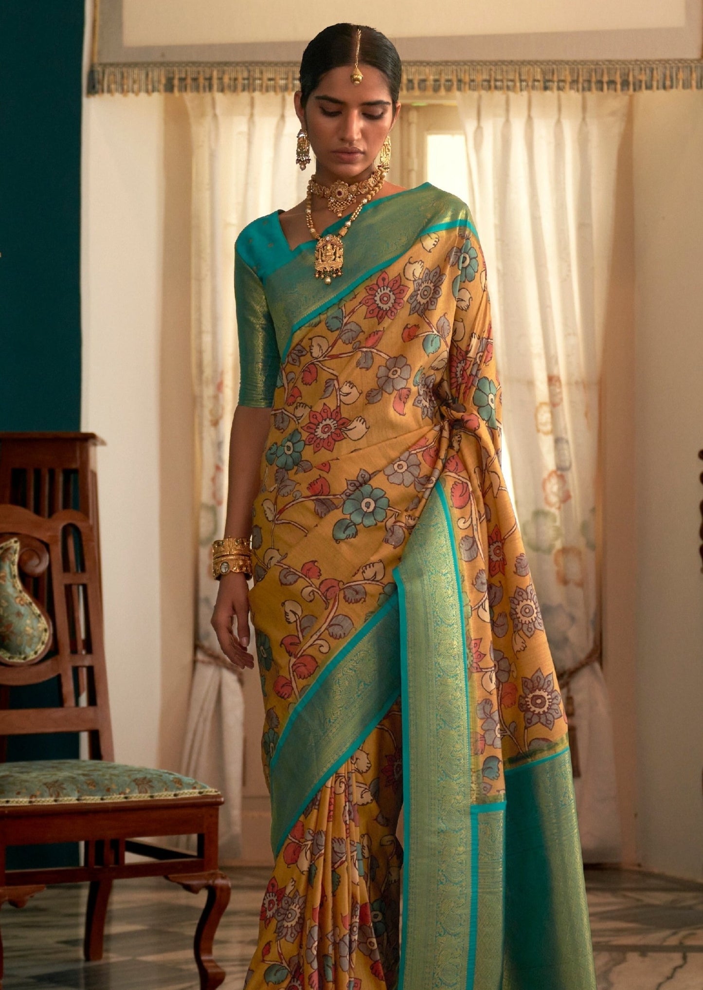 Yellow kalamkari saree & green blouse online with banarasi border zari work.
