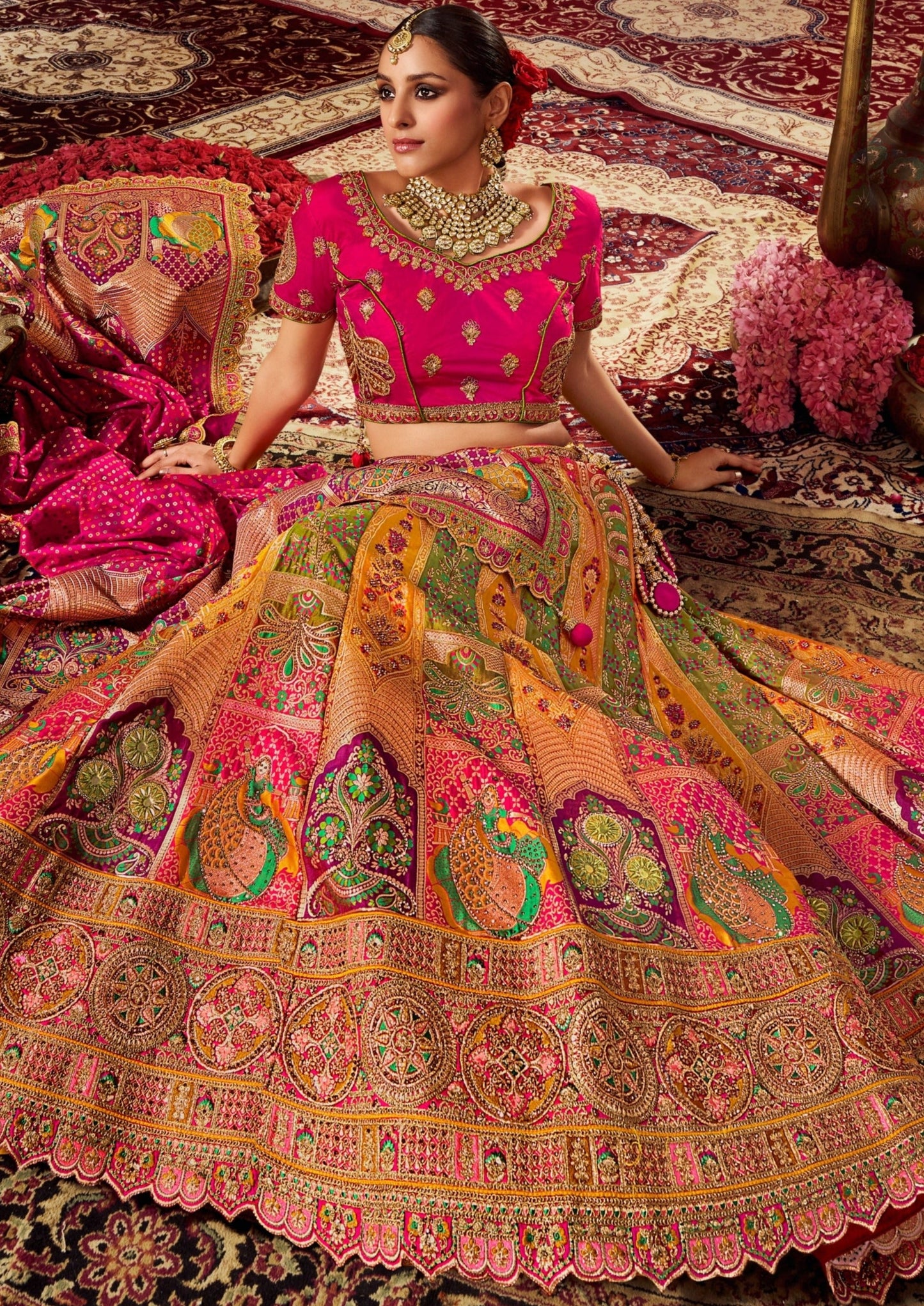 Woman in pink and yellow banarasi silk lehenga choli.