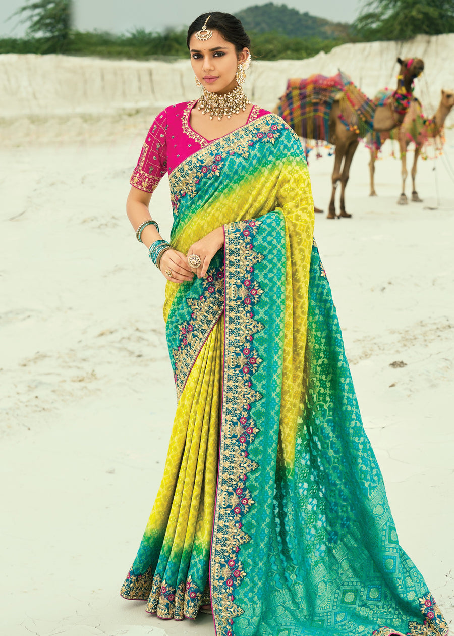 Yellow and turquoise blue ombre khaddi georgette bandhani saree with embroidery for haldi and mehendi functions.