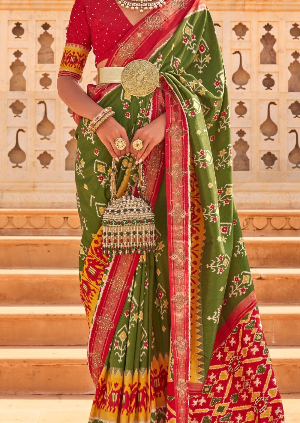Patan patola green multicolor ikat saree online design with red blouse.