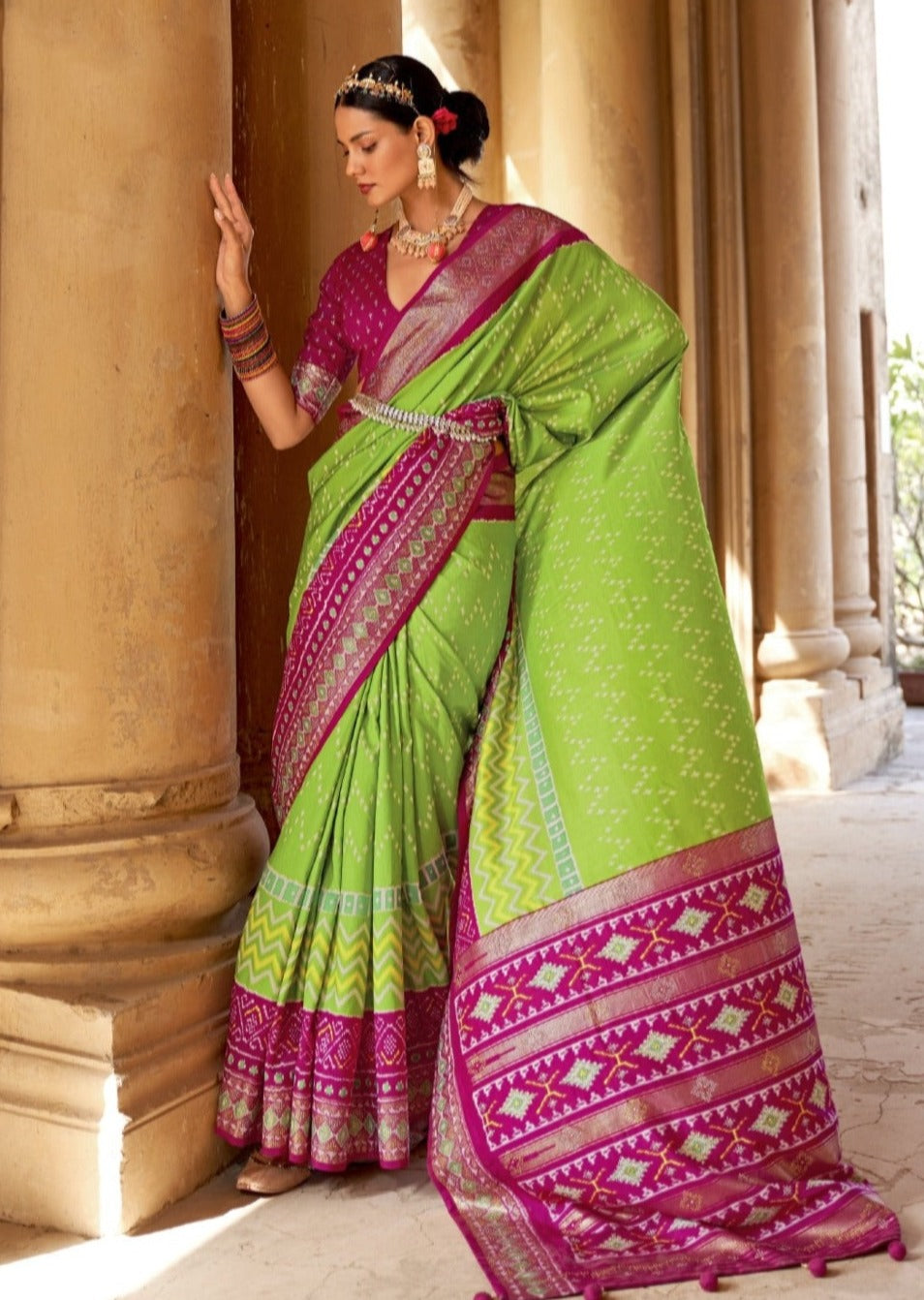 Patola saree online in lawn green colour with contrast pink blouse for wedding function look in india.