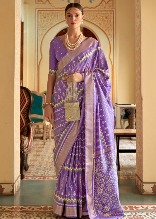 Purple patola saree online shopping design featuring traditional ikkat motifs and a matching blouse.