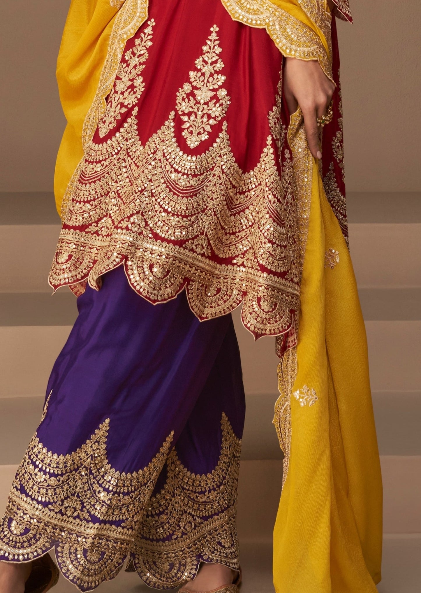 Red suit with blue pant style salwar.