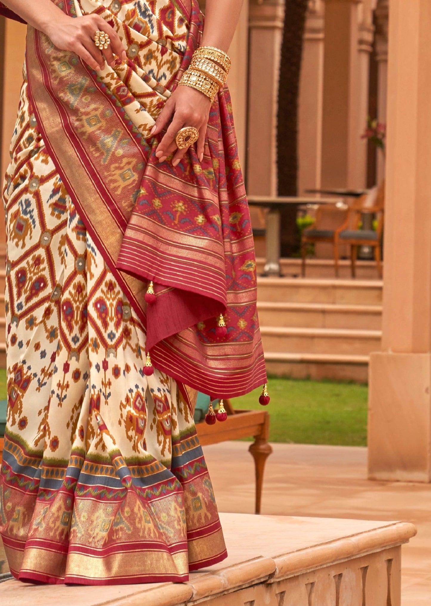 White patola saree pallu with zari border and tassels online hopping.