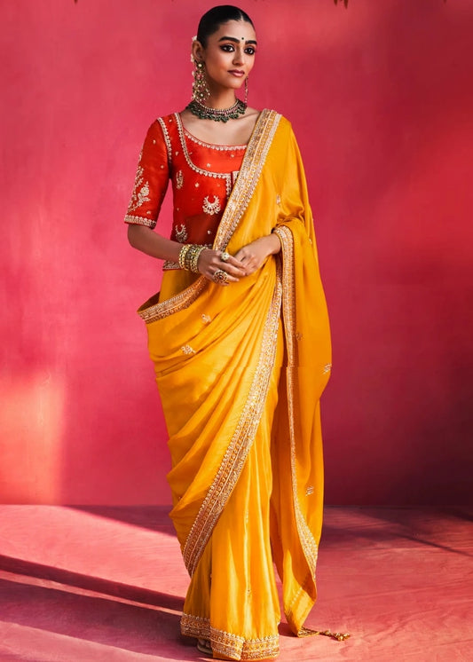 Yellow Silk Embroidered Saree With Orange Blouse