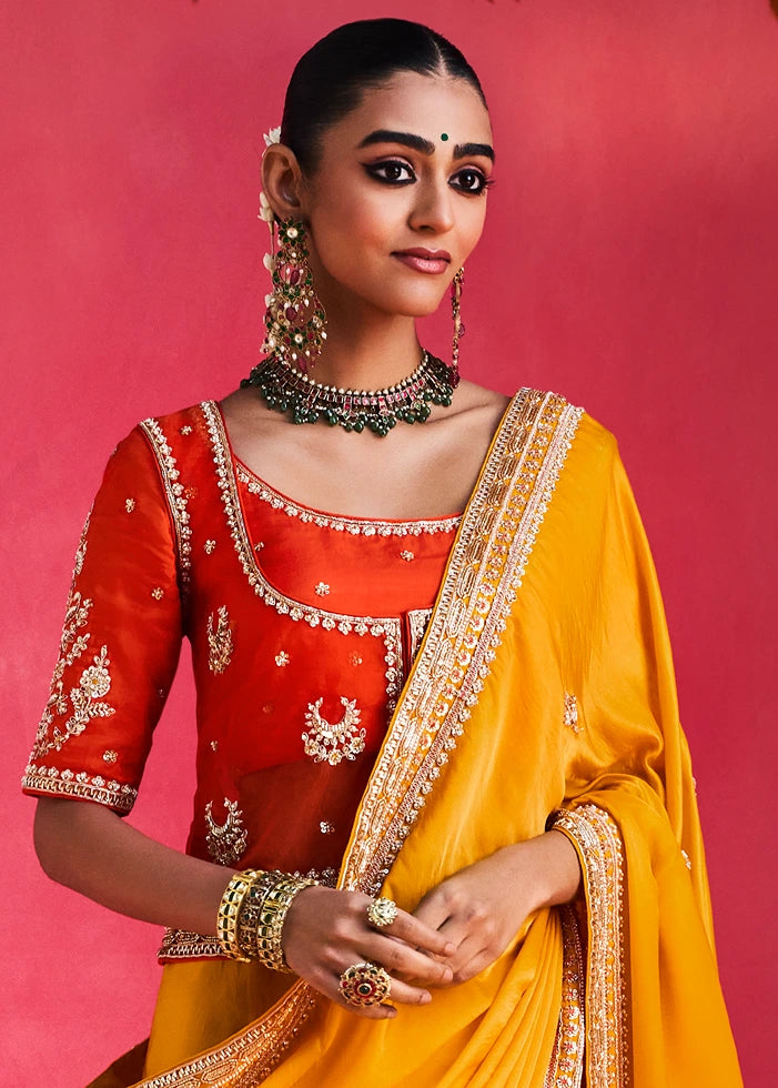 Yellow Silk Embroidered Saree With Orange Blouse