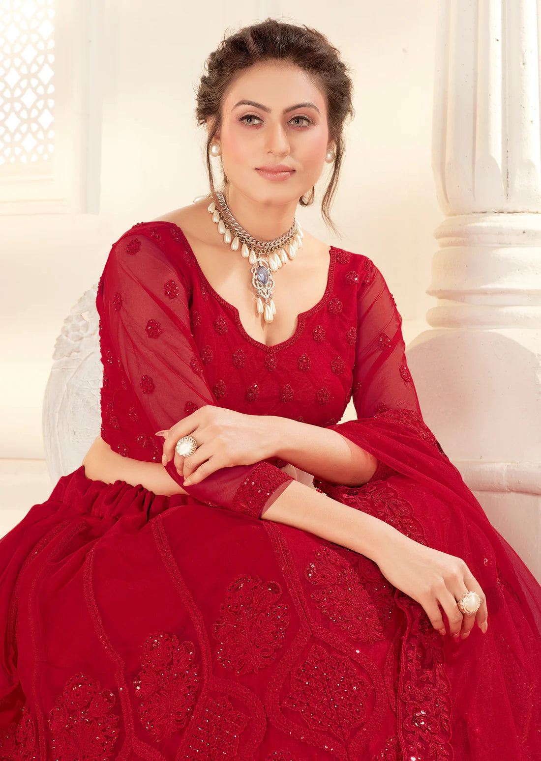 woman sitting in Red Bridal Lehenga