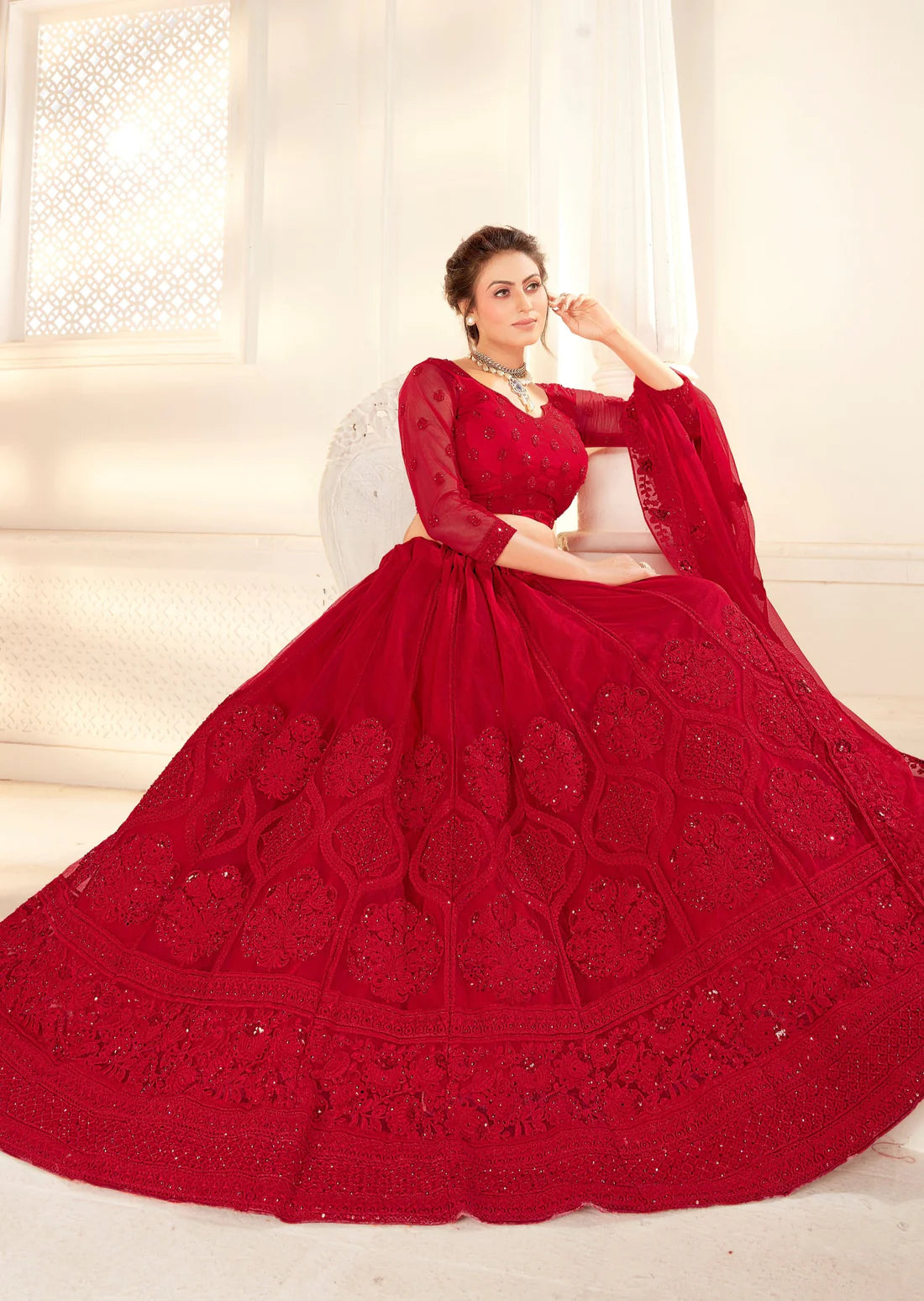 woman sitting in Red Bridal Lehenga