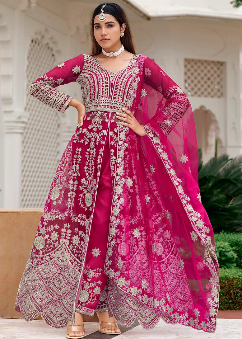 Woman in rani pink embroidered traditional anarkali outfit available on online sale in new york USA. 