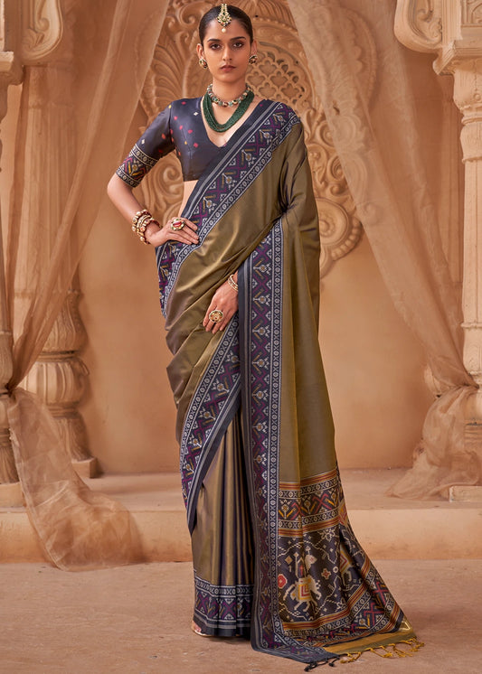 Antique olive green patola silk saree with black blouse, black border and pallu featuring traditional patola hathi popat designs for wedding, navratri and engagement. 