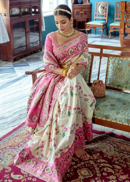 Graceful off white fusion banarasi patola silk luxury saree adorned with a stunning paithani border and pallu for a regal look.