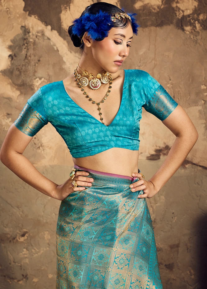 Blouse details of turquoise blue Banarasi saree paired with a traditional gold zari border.