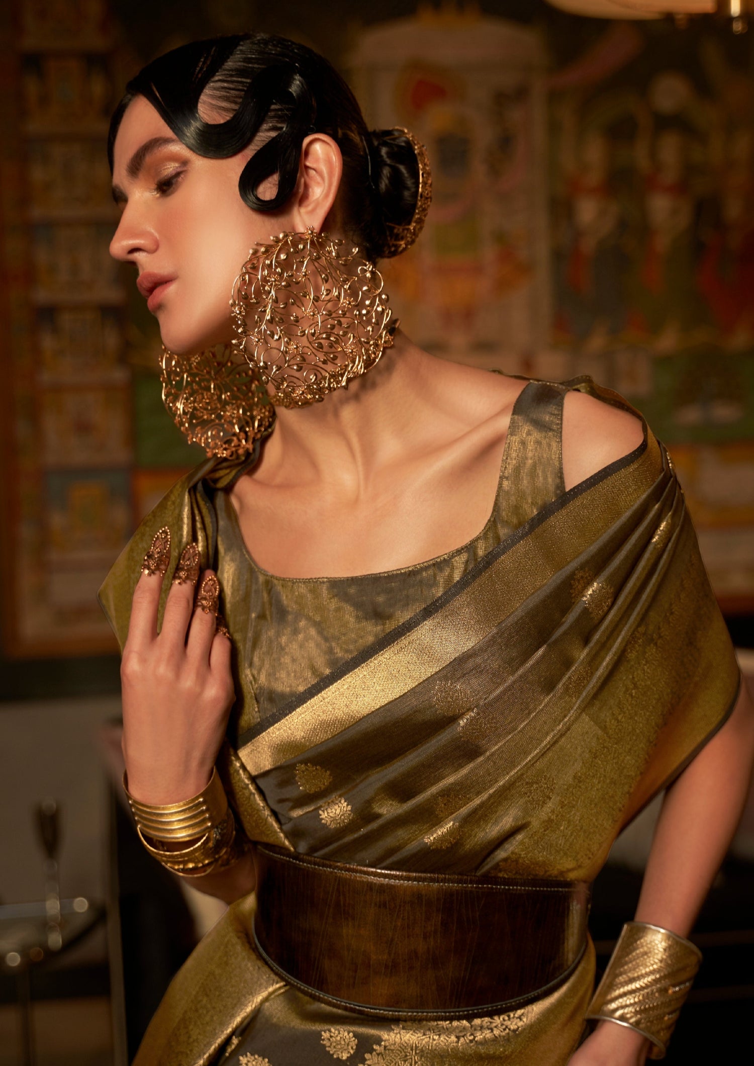 close up photo of woman in black banarasi saree wearing big earrings