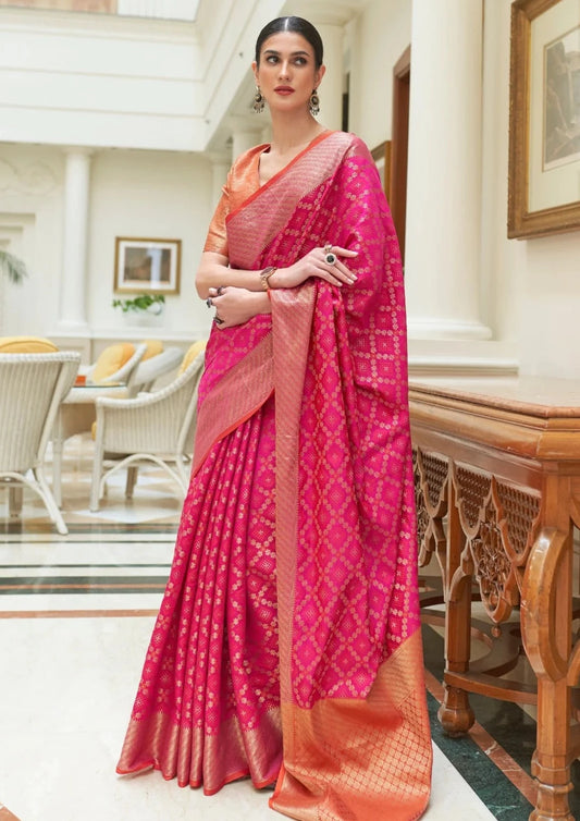 Banarasi silk hot pink bandhani saree online with orange blouse design.