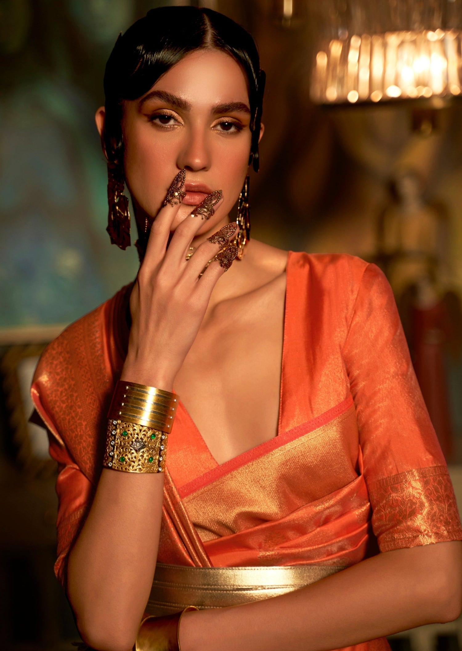 close up image of indian woman's face in orange colour banarasi silk saree blouse